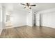 Bright bedroom with wood-look floors and ceiling fan at 8722 W Lewis Ave, Phoenix, AZ 85037