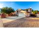 Two-story house with a white garage door and landscaped front yard at 8722 W Lewis Ave, Phoenix, AZ 85037