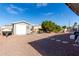 Landscaped backyard featuring a shed, pergola, and stone pathway at 9120 E Chambers St, Mesa, AZ 85208