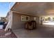 Covered carport with a gray exterior and storage at 9120 E Chambers St, Mesa, AZ 85208