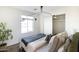 Bright bedroom with a green velvet headboard and wood floors at 9625 N 1St St, Phoenix, AZ 85020