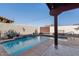 Sparkling blue pool with a waterfall feature and covered patio at 10188 E La Palma Ave, Gold Canyon, AZ 85118