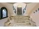 Interior entryway with a curved staircase and tiled flooring at 10420 E Morning Vista Ln, Scottsdale, AZ 85262