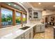 Elegant kitchen with white cabinets, an island, and a view to backyard at 10420 E Morning Vista Ln, Scottsdale, AZ 85262