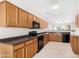 Spacious kitchen with dark countertops and oak cabinets at 11105 E Segura Ave, Mesa, AZ 85212