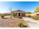 Tan, single-story home with attached garage and desert landscaping at 15580 S Bentley Dr, Arizona City, AZ 85123