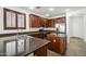 Kitchen with an island, stainless steel appliances, and dark wood cabinets at 16048 W Mercer Ln, Surprise, AZ 85379