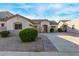 Single-story house with neutral exterior, landscaping, and a paved driveway leading to the garage at 19371 E Carriage Way, Queen Creek, AZ 85142