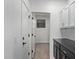 Laundry room with dark cabinets, white countertop and window at 19371 E Carriage Way, Queen Creek, AZ 85142