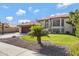 Exterior view of a house with a manicured lawn and a basketball court at 19436 N 36Th Pl, Phoenix, AZ 85050