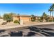 House exterior featuring a three-car garage and manicured landscaping at 19714 N Rim Dr, Surprise, AZ 85374