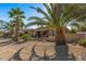 Back exterior view of single story home with desert landscaping and palm trees at 19714 N Rim Dr, Surprise, AZ 85374