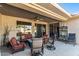 Relaxing covered patio with seating area and ceiling fan at 19714 N Rim Dr, Surprise, AZ 85374