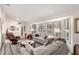 Spacious living room featuring neutral colors, plush sofas, and large windows at 20205 N Broken Arrow Dr, Sun City West, AZ 85375