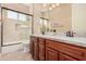 Bathroom with double vanity, granite countertop, and shower at 2380 N Horseshoe Cir, Casa Grande, AZ 85122