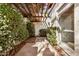 Private patio area with a pergola covered in blooming vines at 2553 N Miller Rd, Scottsdale, AZ 85257