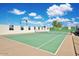 Community tennis court with green surface and light-colored perimeter at 2553 N Miller Rd, Scottsdale, AZ 85257