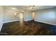 Spacious living room with dark wood-look floors and ceiling fan at 4222 N 48Th Ave, Phoenix, AZ 85031