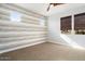 Bright bedroom featuring a stylish accent wall and carpeting at 4779 N 205Th Gln, Buckeye, AZ 85396