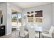 Bright dining room with glass table and chairs, and sliding doors to patio at 4779 N 205Th Gln, Buckeye, AZ 85396