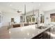 Kitchen island with sink, stainless steel appliances, and view to living room at 4779 N 205Th Gln, Buckeye, AZ 85396