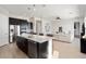 Modern kitchen with large island, stainless steel appliances, and dark cabinets at 4779 N 205Th Gln, Buckeye, AZ 85396