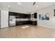 Modern kitchen with dark cabinetry and stainless steel appliances at 4779 N 205Th Gln, Buckeye, AZ 85396