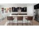 Modern kitchen boasts dark cabinetry, quartz countertops, and stainless steel appliances at 4779 N 205Th Gln, Buckeye, AZ 85396