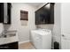 Laundry room with washer, dryer, and ample cabinetry at 4779 N 205Th Gln, Buckeye, AZ 85396