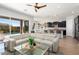 Open living area features a large sectional sofa, glass coffee table, and views to the pool at 4779 N 205Th Gln, Buckeye, AZ 85396