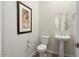 Stylish powder room with pedestal sink and modern toilet at 4779 N 205Th Gln, Buckeye, AZ 85396