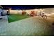 Landscaped backyard with artificial turf, patio, and string lights at 4830 E Palm Ln, Phoenix, AZ 85008