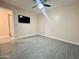 Simple bedroom with tile floors and a mounted TV at 4830 E Palm Ln, Phoenix, AZ 85008