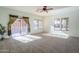 Living room with sliding glass doors leading to a patio, and neutral colored walls at 7019 S Golfside Ln, Phoenix, AZ 85042