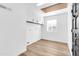 Bright laundry room featuring white cabinets and vinyl flooring at 729 N 96Th Pl, Mesa, AZ 85207