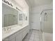 Clean bathroom with double vanity, shower, and separate tub at 7887 N 16Th St # 116, Phoenix, AZ 85020
