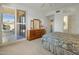 Spacious bedroom with patio access, dresser, and a queen-size bed at 7887 N 16Th St # 116, Phoenix, AZ 85020