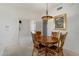 Bright dining room with wooden table and chairs, featuring a chandelier and artwork at 7887 N 16Th St # 116, Phoenix, AZ 85020