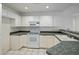 Kitchen with white cabinets, tile countertops, and a dishwasher at 7887 N 16Th St # 116, Phoenix, AZ 85020