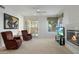 Living room with fireplace, two armchairs, and access to patio at 7887 N 16Th St # 116, Phoenix, AZ 85020