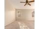 Primary bedroom with carpet, ceiling fan and natural light at 8729 W Tuckey Ln, Glendale, AZ 85305