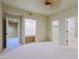 Bedroom with built-in desk and access to bathroom and closet at 10040 E Happy Valley Rd # 204, Scottsdale, AZ 85255