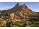 Aerial view of a golf course nestled in the mountains at 10040 E Happy Valley Rd # 204, Scottsdale, AZ 85255