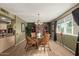 Dining area with glass table and four chairs, hardwood floor at 10274 N 109Th Ave, Sun City, AZ 85351