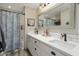 Updated bathroom with double vanity, white subway tile, and a shower/tub combo at 1066 N Oro Vis, Litchfield Park, AZ 85340