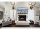 Living room fireplace with mounted deer heads above at 1066 N Oro Vis, Litchfield Park, AZ 85340