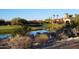 Community clubhouse near a pond and golf course at 14401 W Gunsight Dr, Sun City West, AZ 85375