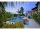 Relaxing pool area with patio furniture and lush tropical plants at 14401 W Gunsight Dr, Sun City West, AZ 85375