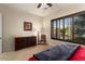 Guest bedroom with dresser, chair, and large window with shutters at 16488 W Wilshire Dr, Goodyear, AZ 85395