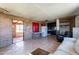 Open living room with tile floors and access to a patio at 1907 E Foothill St, Apache Junction, AZ 85119